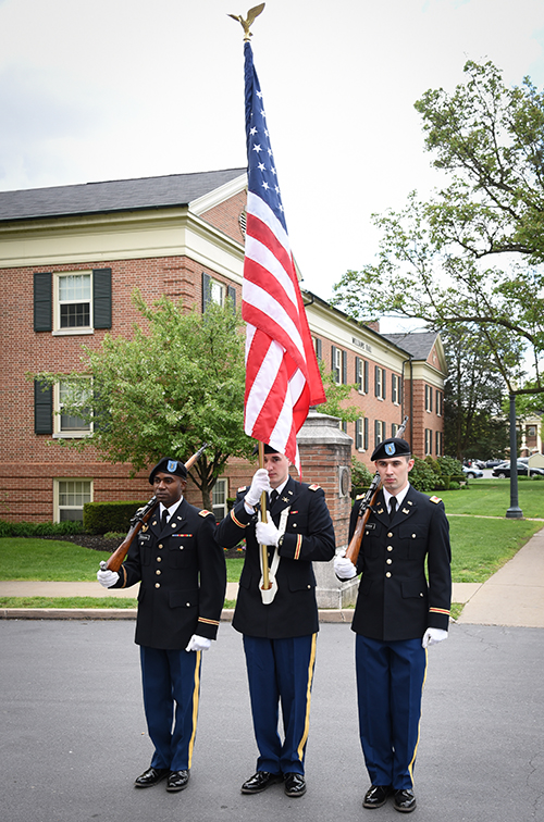 A color guard starts the processional to the Quad.
